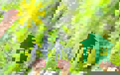 Image shows cutouts of a family, house, and sun.