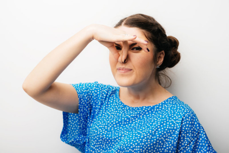 Woman holding her nose