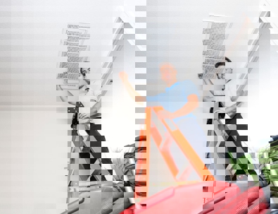 HVAC technician on a ladder.