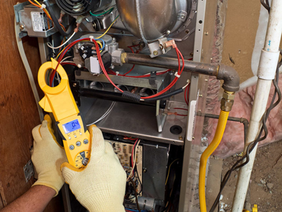 HVAC repair with a technician using a clamp meter