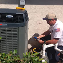 service tech outside with a heat pump
