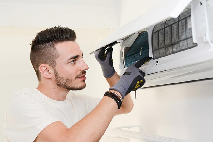 man working on a ductless ac unit